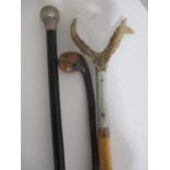 A silver mounted walking cane along with two others