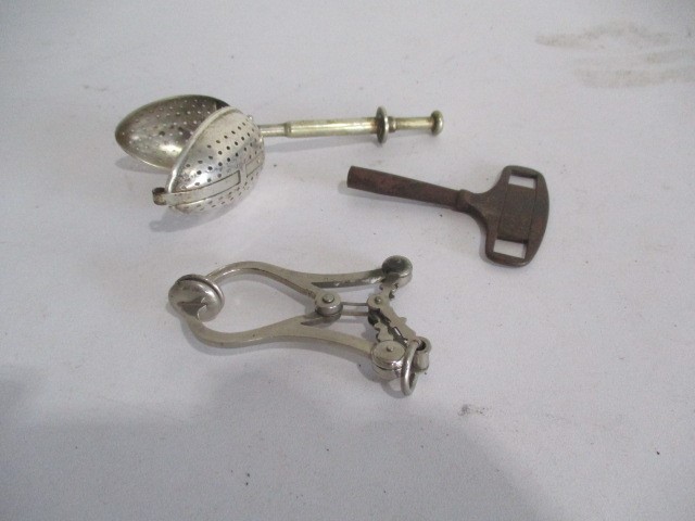 A collection of various items including leather case tape measure, clockwork key, nut cracker, pen - Image 10 of 11