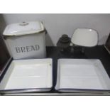 An enamelled bread bin and two trays along with a set of scales