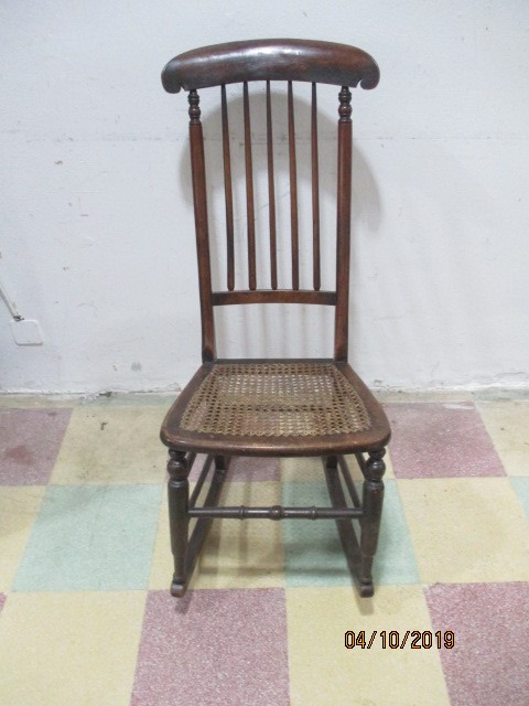 A Victorian cane seated rocking chair