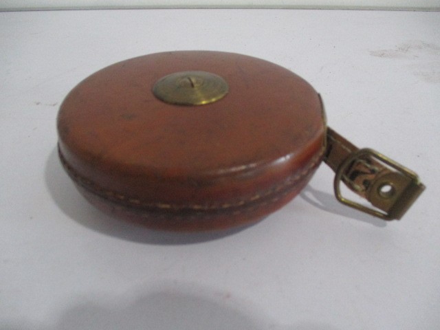 A collection of various items including leather case tape measure, clockwork key, nut cracker, pen - Image 2 of 11