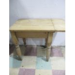 A vintage pine kitchen table with small leaf