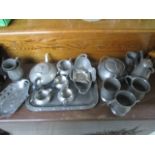A collection of various Pewter items including tankards.