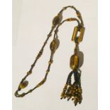 An Art Deco 'Flappers' tigers eye necklace.