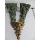A pair of pottery wall sconces in the form of ,mermaids along with one other