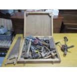 A collection of carpenters tools stored in wooden box