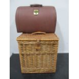 A leather briefcase along with a wicker picnic basket