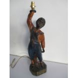 A reproduction advertising figure "New Orleans News" of a boy holding a lamp, 59cm height