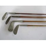 Three hickory shafted golf clubs along with one other