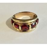 A 9ct gold garnet five stone ring. Size O