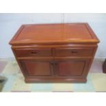 A Chinese hardwood cupboard with two drawers