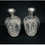 A pair of hallmarked silver topped cut glass scent bottles, one A/F
