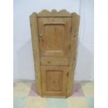 A small pine corner cupboard