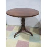 An antique oak tip up table