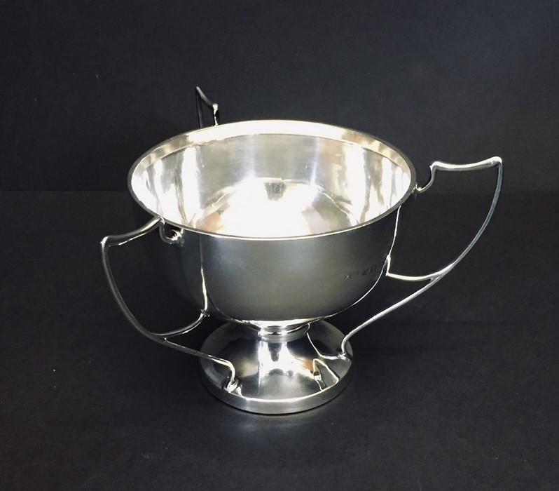 A hallmarked silver three handled tyg.