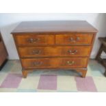 A mahogany inlaid chest of four drawers