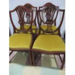 A set of four upholstered dining chairs