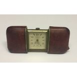 A Hermes travel clock/purse watch with sliding leather case to reveal the Art Deco style square