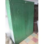 A large green painted two door cupboard