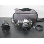 An Olympus OM10 camera along with Sirius 60-300mm zoom lens etc