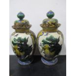 A pair of Oriental vases and covers decorated with exotic birds, 38.5cm height