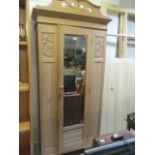 An Art Nouveau wardrobe with mirrored door