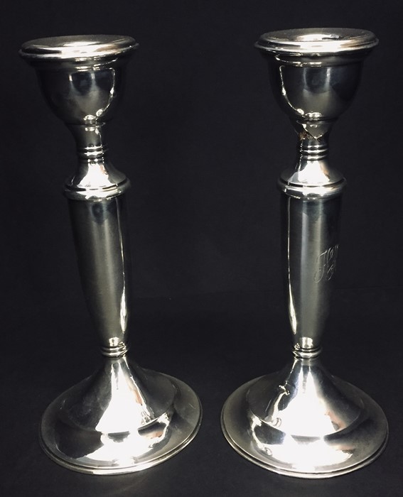 A pair of hallmarked silver candlesticks, one A/f. Birmingham 1919