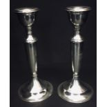 A pair of hallmarked silver candlesticks, one A/f. Birmingham 1919
