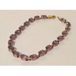 A 9ct gold and amethyst bracelet. Weight 6.8g