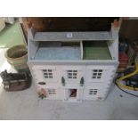 A dolls house with various furniture etc.