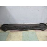An antique cast iron fender
