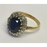 A diamond and sapphire cluster ring set in unmarked gold.