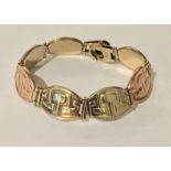 A tricolour 9ct gold bracelet. Weight 17..8g