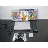 A Playstation 2 slim with games, controller, memory card etc