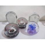 A collection of five paperweights including Caithness