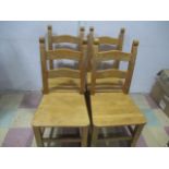A set of four beech dining chairs