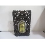 An oriental bronze gong on hard wood stand, decorated with dragons etc - one eye missing