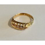 AN 18ct gold 'boat' ring set with five diamonds, dated 1913