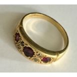 An 18ct gold ring set with garnets and diamonds. Total weight 6g