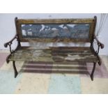 A child's garden bench with wrought iron sides and back