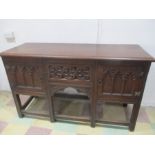 An oak sideboard with carved decoration