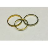 Two 9ct gold wedding bands (4g) along with an 18ct gold band (1.4g)