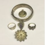 A silver bangle, silver rings, pendant etc