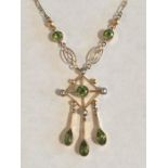 A 9ct gold pendant set with peridot and seed pearls.