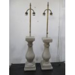 A pair of adjustable height lamps of pillar form with twin brass fittings