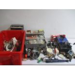 A collection of fishing equipment including reels, weights, knife, scales, lures, hooks etc