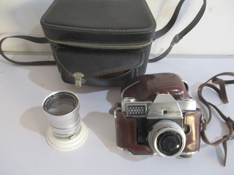 A Kodak Retina Reflex IV camera with Schneider- Kreuznach lens along with a similar 4/135mm lens