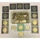 A collection of various coins and commemorative crowns.