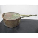 A large copper saucepan and lid