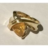 A 9ct gold ring set with a sherry topaz and diamond